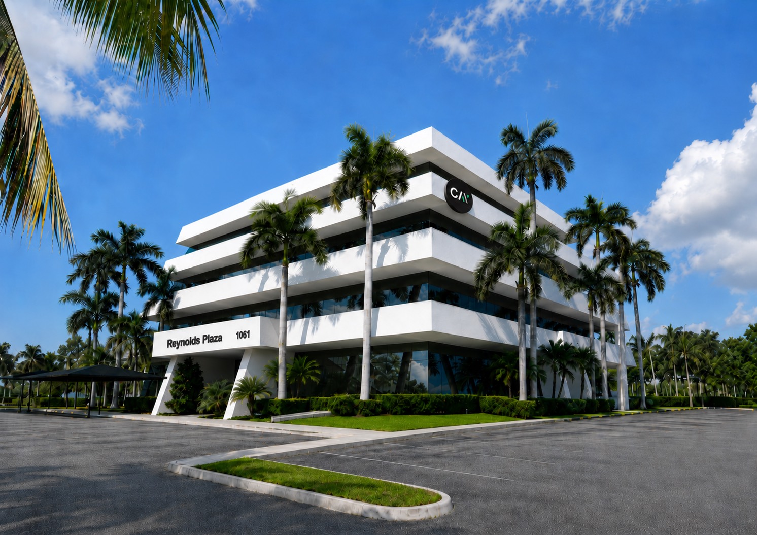Cay Digital's office at Reynolds Plaza in Jupiter, Florida — a white modern building framed by palm trees